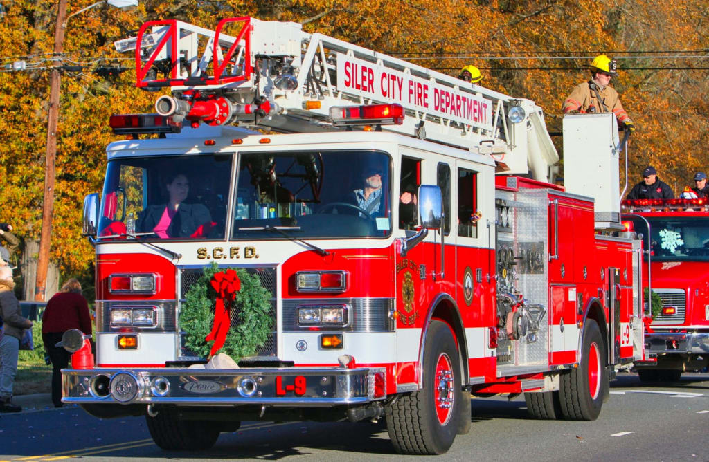 Fire truck driving down city road.