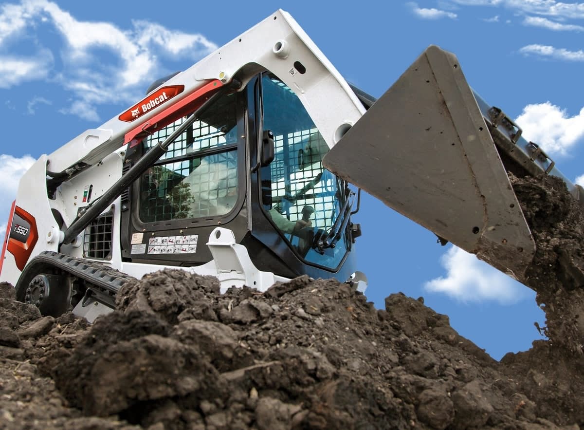 White piece of heavy duty equipment with foot controls, auxiliary hydraulics, and durable tires at a low cost of buying.