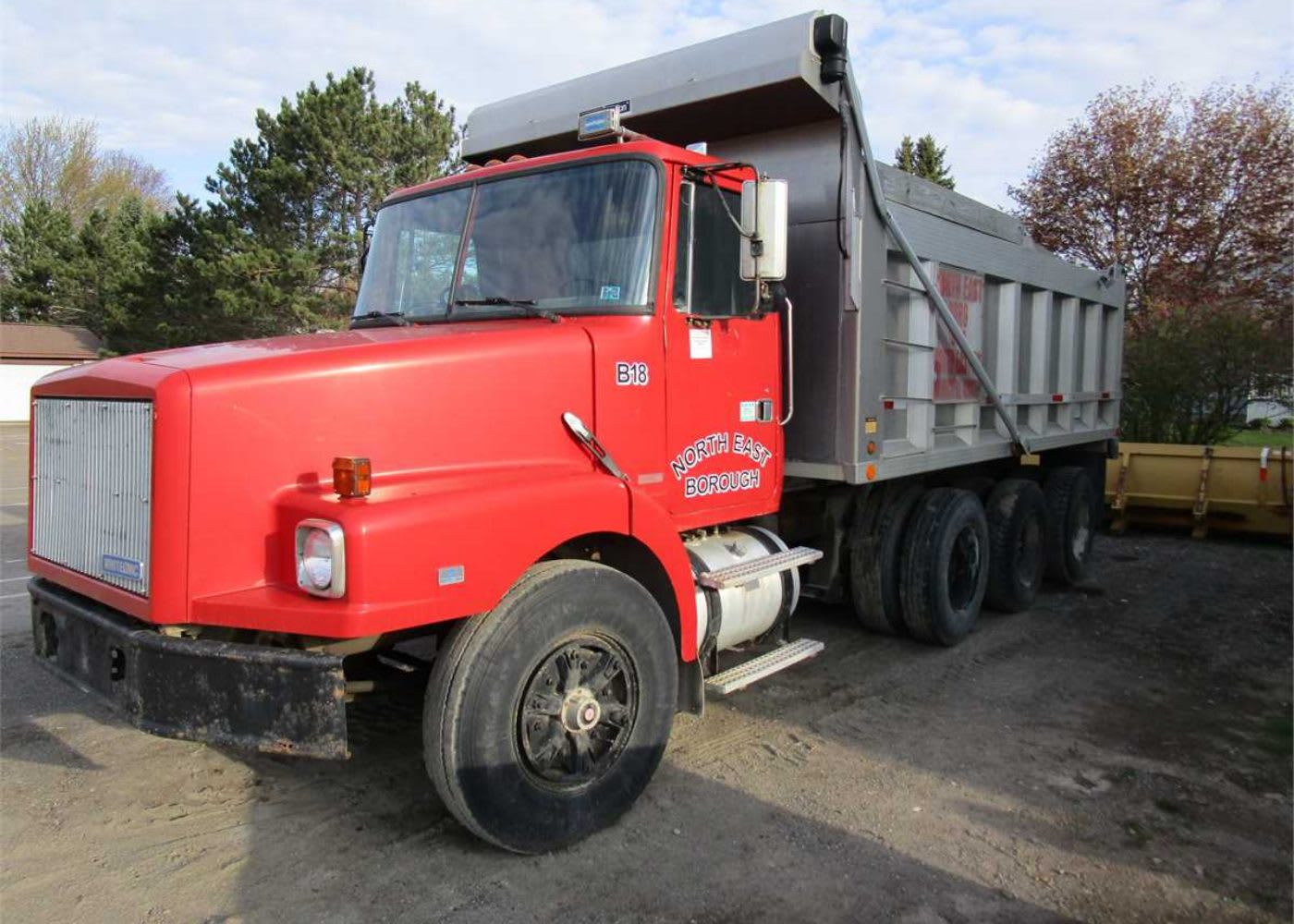 Red and gray standard dump truck
