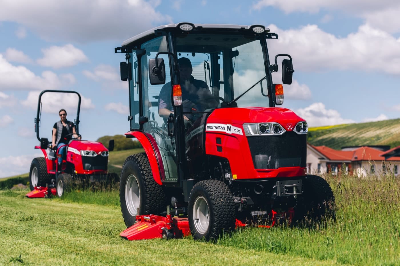 MF 1700 M tractor mowing grass in a field.