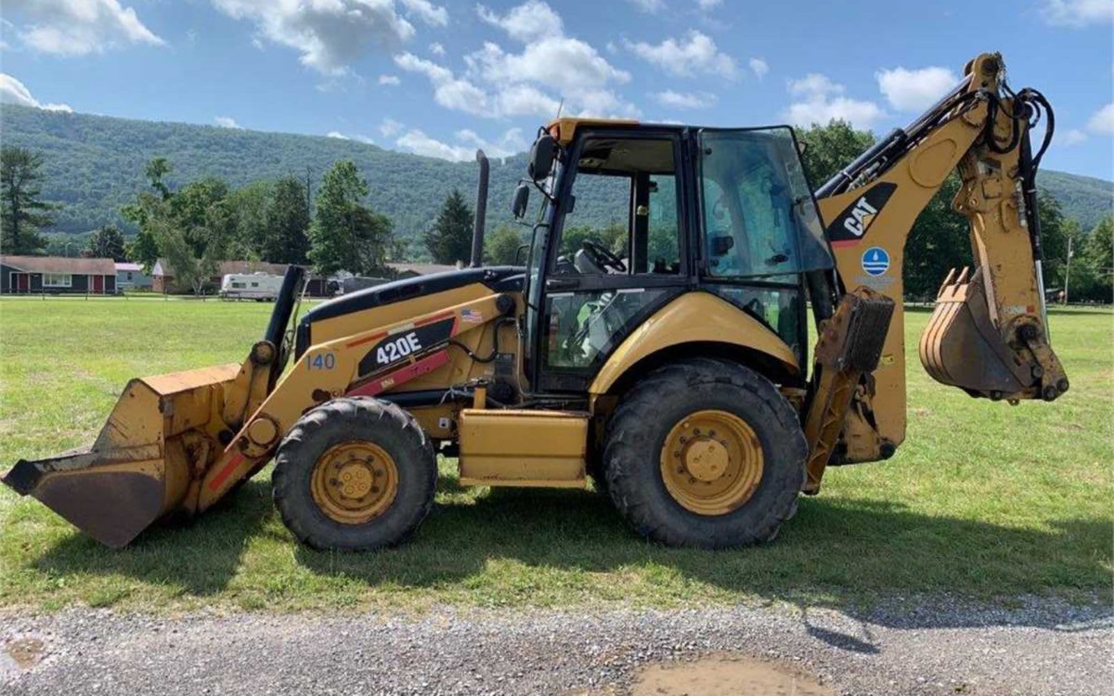 Backhoe loader parked in a field.