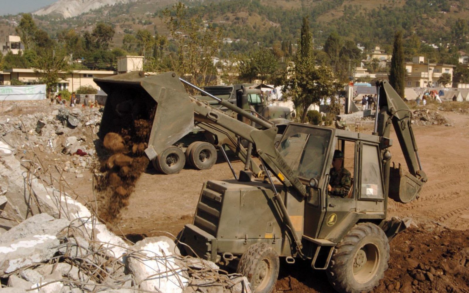 Backhoe loader earthmoving at a worksite.