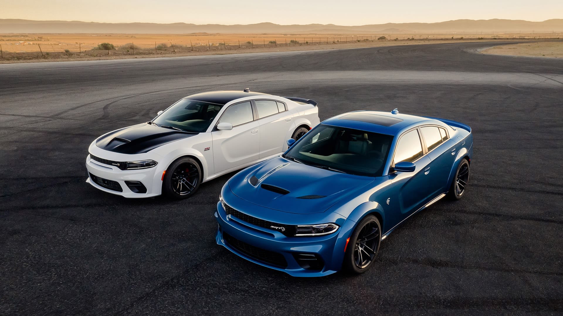 2020 Dodge Charger SRT Hellcat parked on pavement in the desert at sunset.