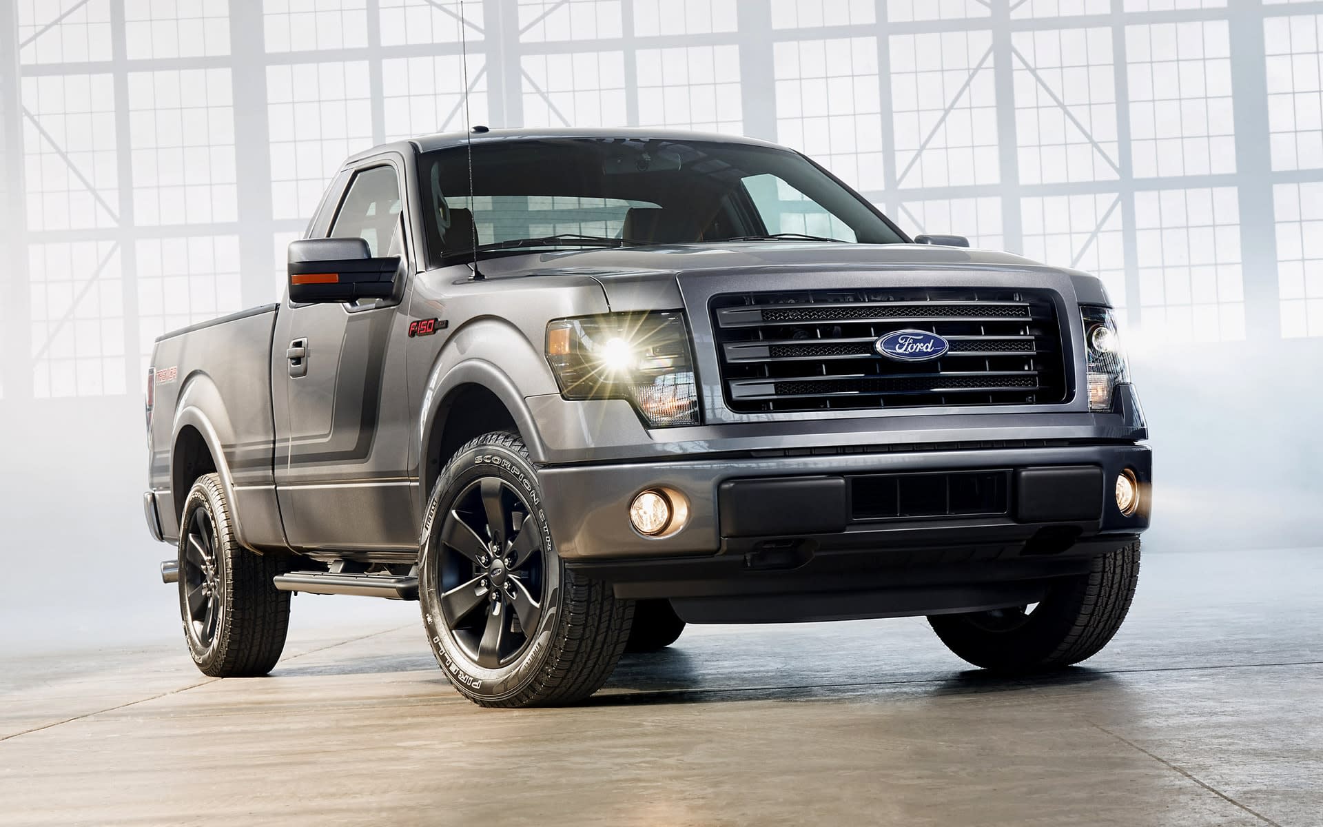 Silver 2013 model year Ford F-150 single cab in a large building with natural light coming in the windows.