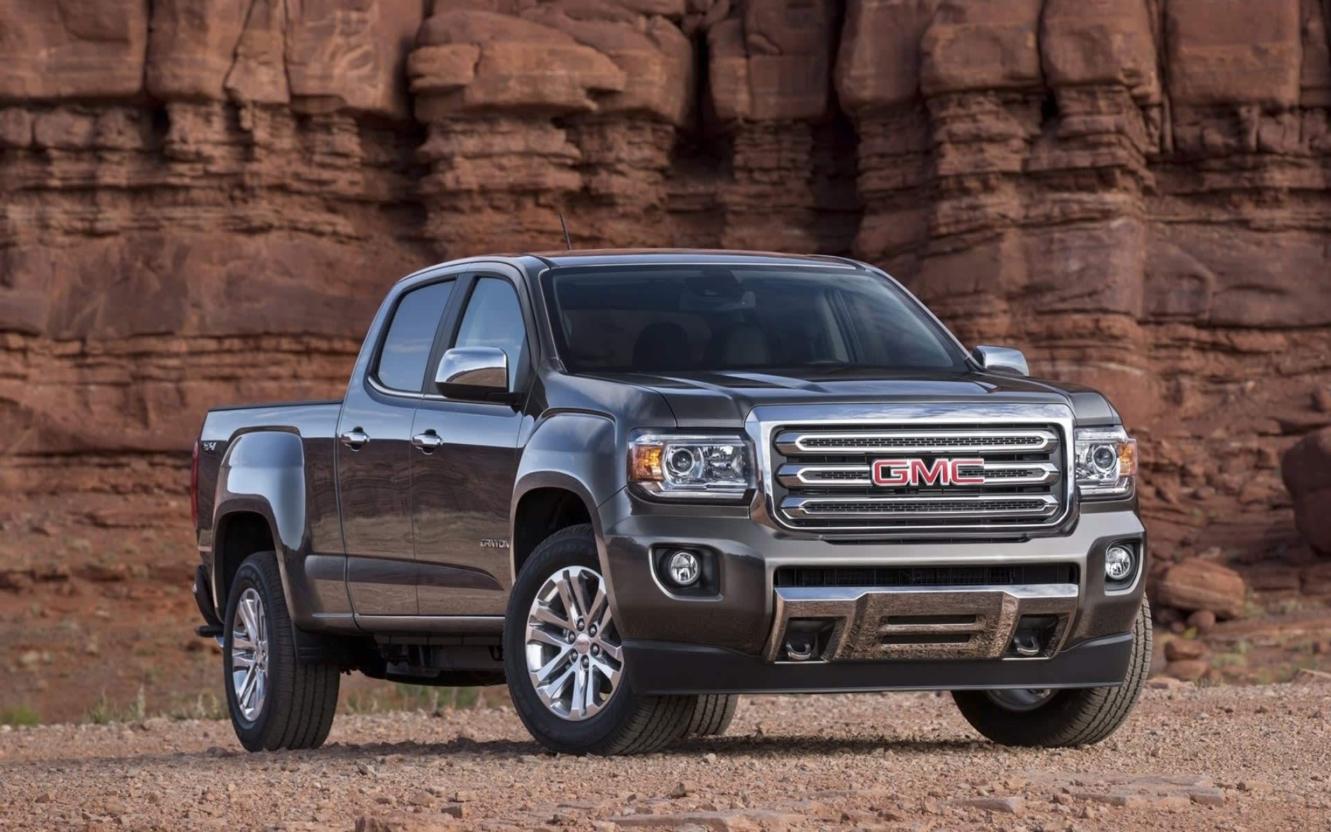 Dark grey GMC Canyon new truck parked in the mountains.