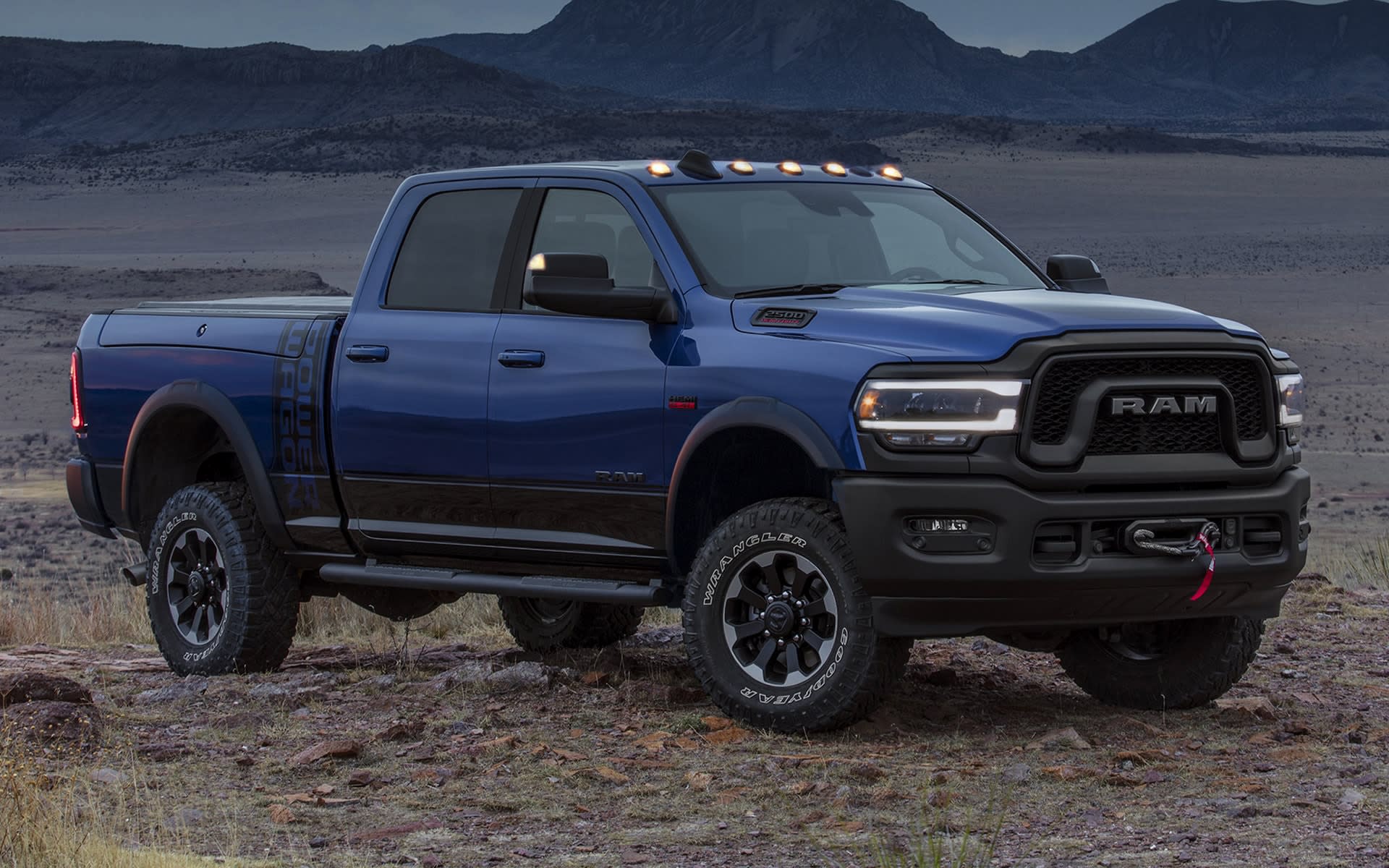 Dark blue Ram truck parked at sunset.