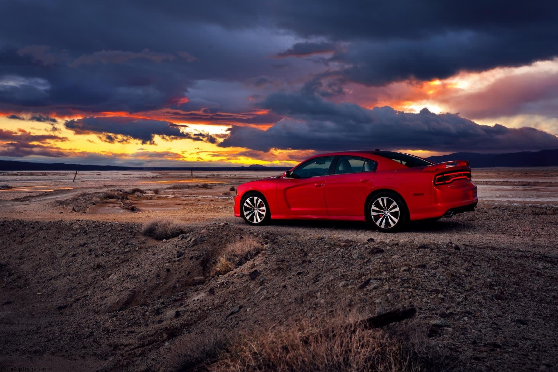 Red 2011 model year Dodge Charger on a road.