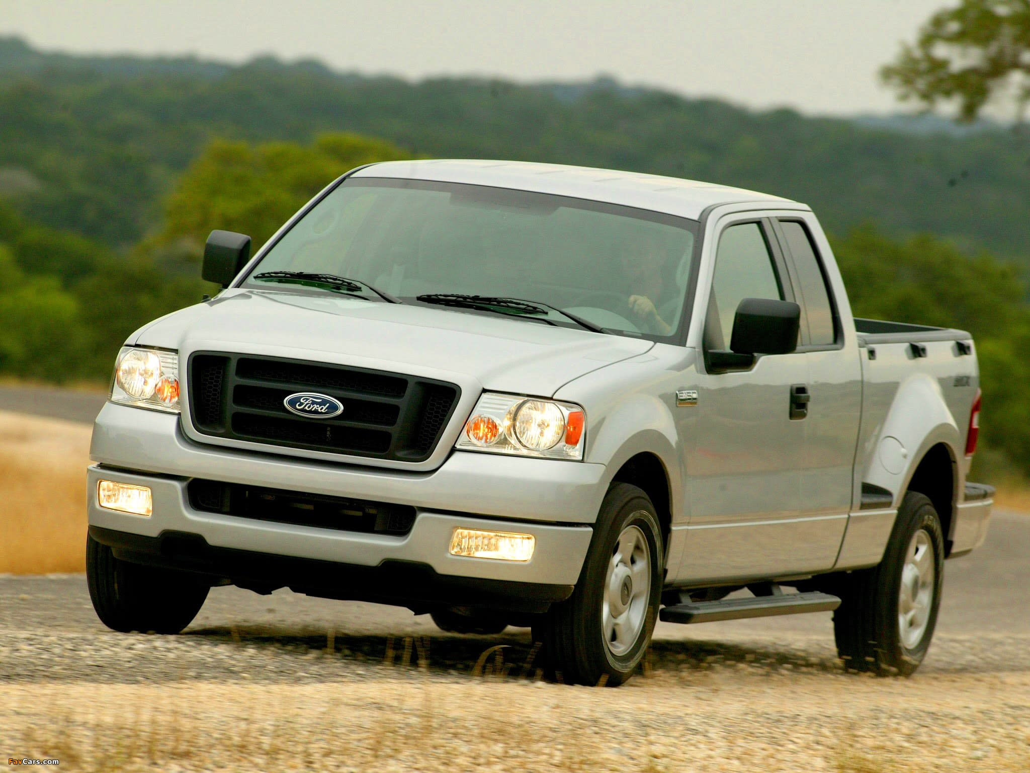 Generation 11 (2004-2008) Ford F-150 truck in silver colour driving on a road.