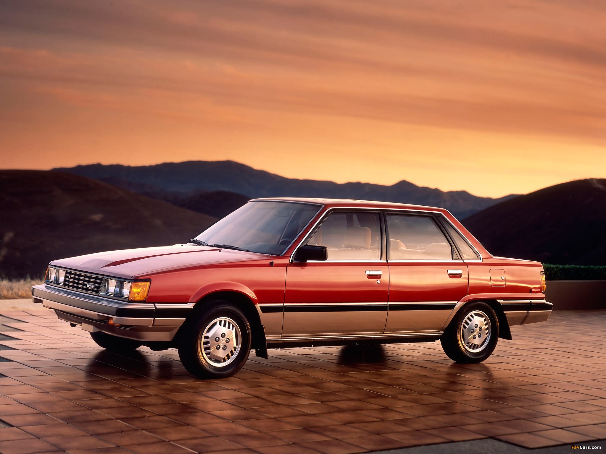 1982 used Toyota Camry car parked at sunset with mountains in the background.