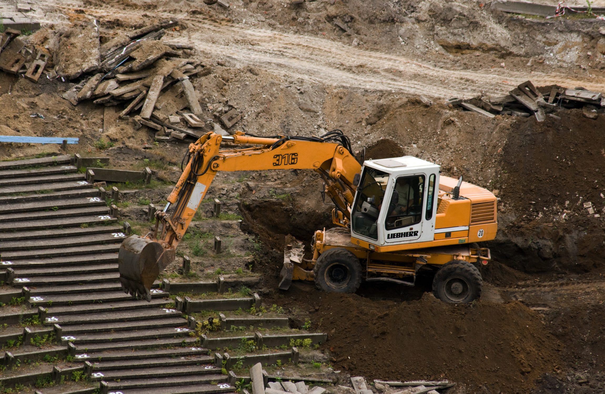 A wheeled excavator at a construction site.