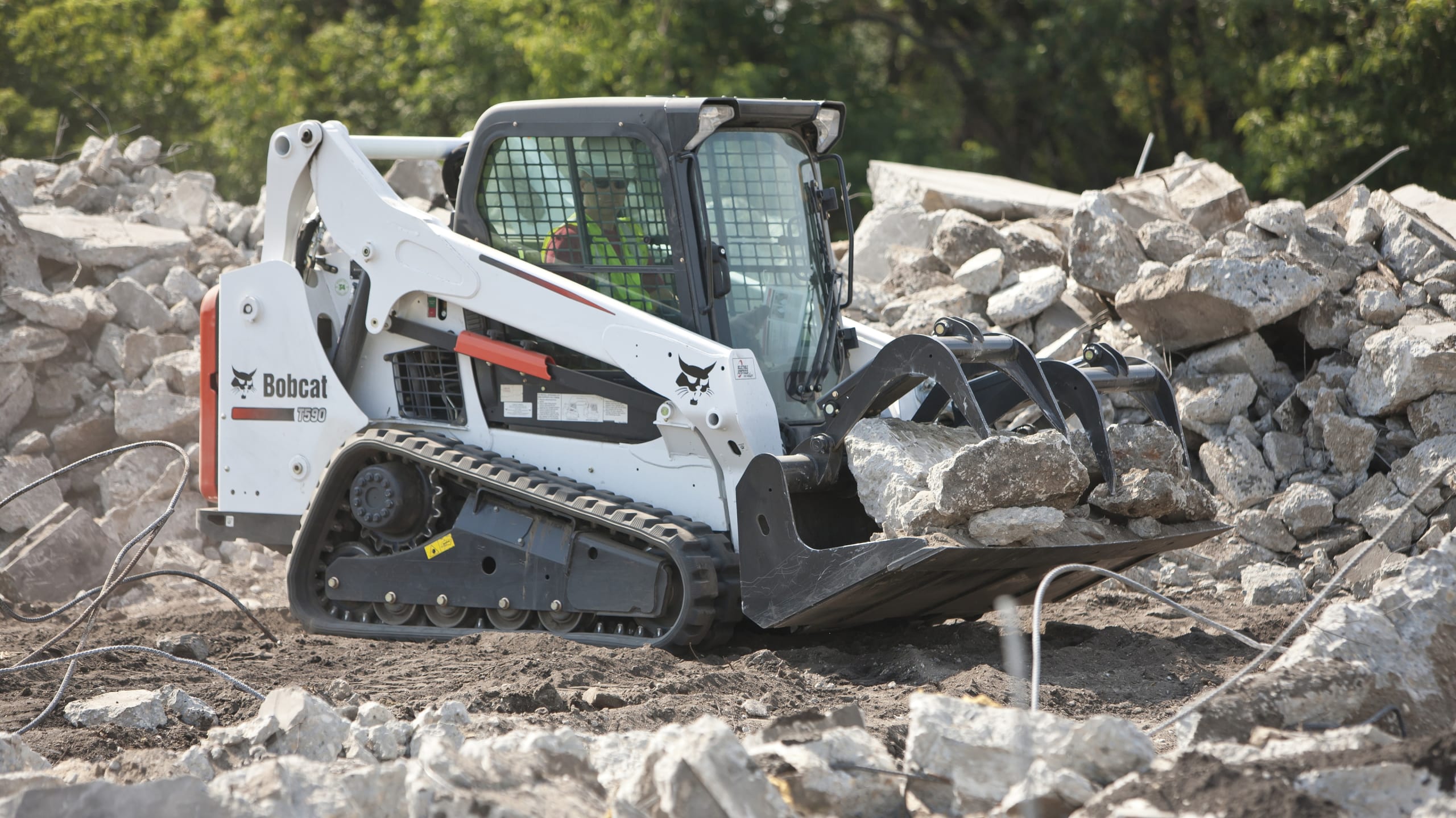 White skid steer loader with modfied wheels which are good for landscaping.