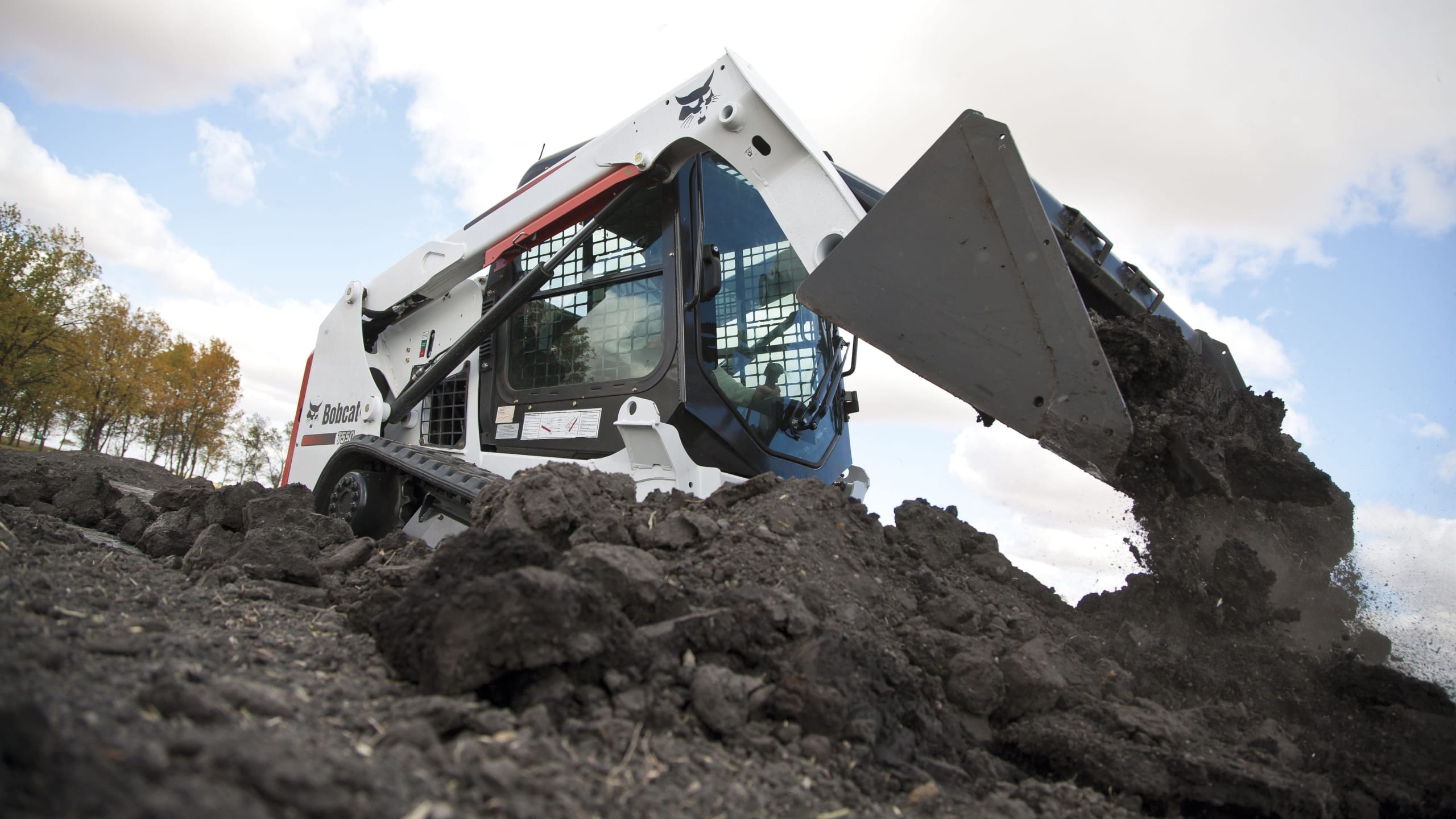White skid steer loader, good for landscaping and other construction tasks.