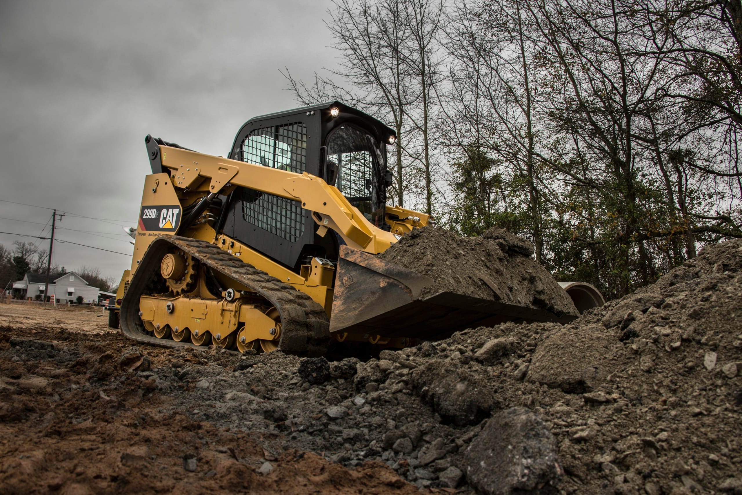 CAT skid steer moving dirt.