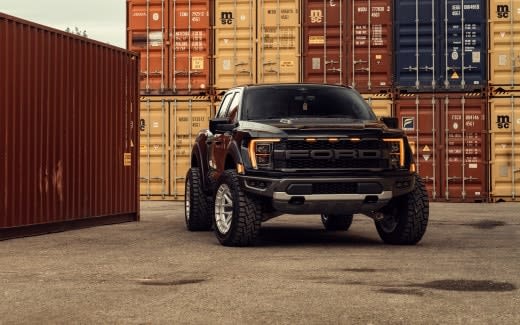 Ford F150 Raptor with diesel engine parked amongst shipping containers.