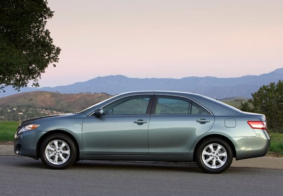 2009 Toyota Camry car parked at dusk beside a tree.
