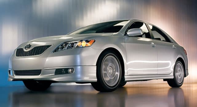 Silver 2008 Toyota Camry parked in a show room.