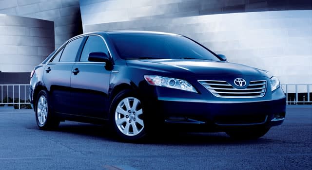 Black 2007 Toyota Camry parked beside a building.