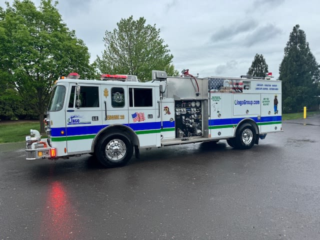 The Lingo Group in the community with a fire truck. The Lingo Group in the community with a fire truck.