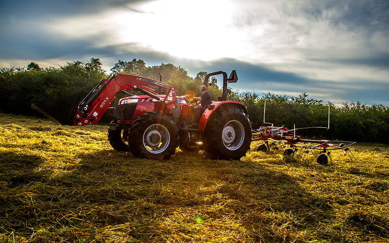 MF 4708 model picking grass for hay and forage in a field.