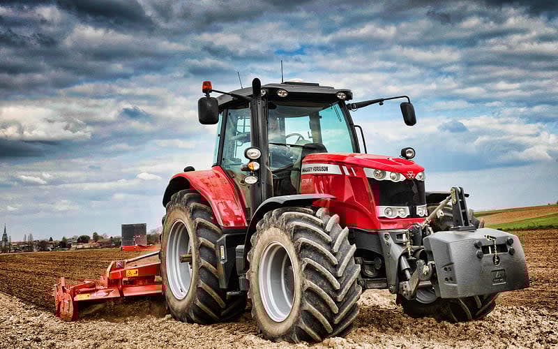 Massey Ferguson 6718S, part of the MF 6S series, plowing a field.