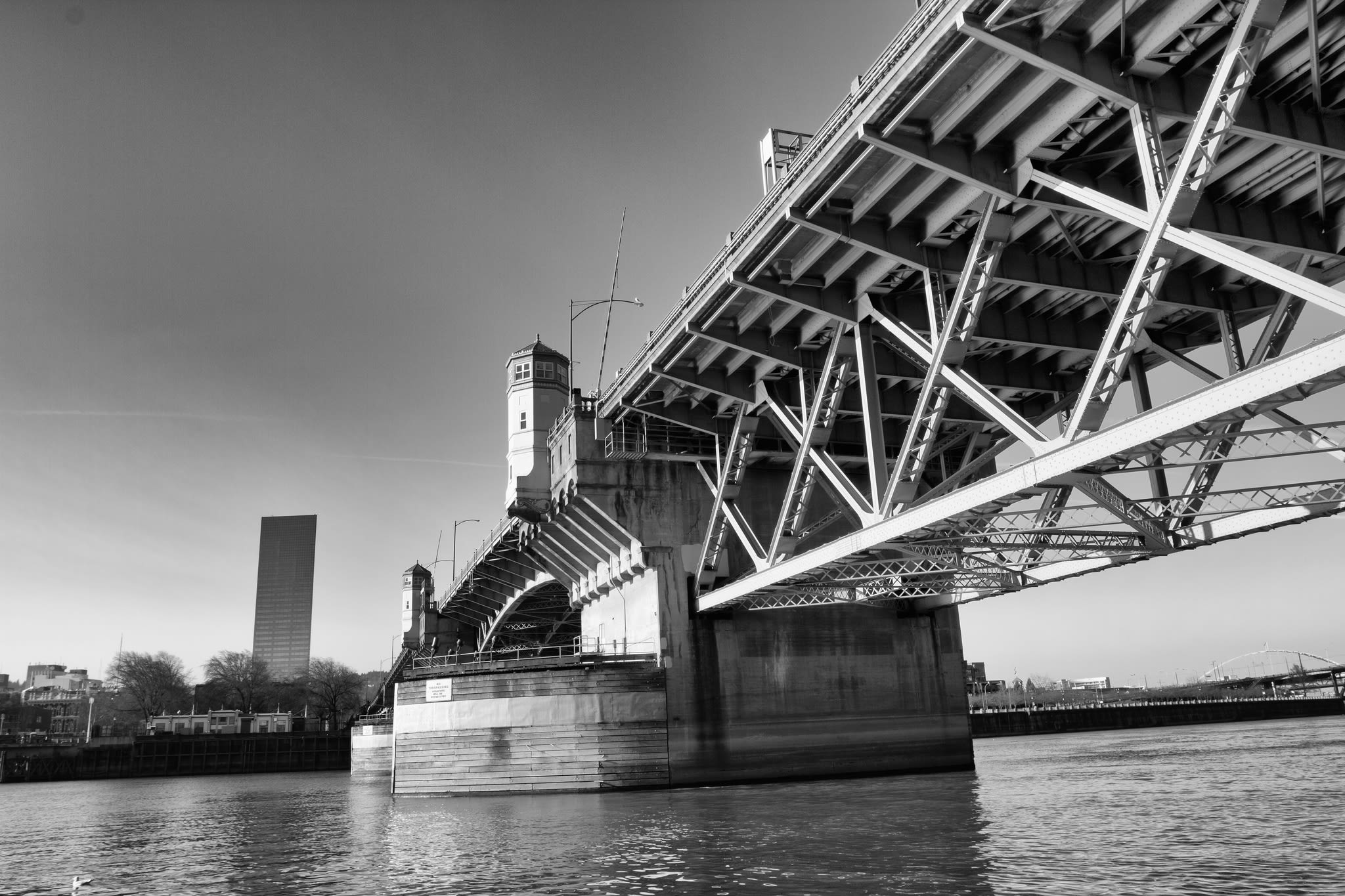 Burnside Bridge in Portland, Oregon, showcasing its architectural details and surrounding waterfront, symbolizing the connection to Burnside & Co.'s branding.