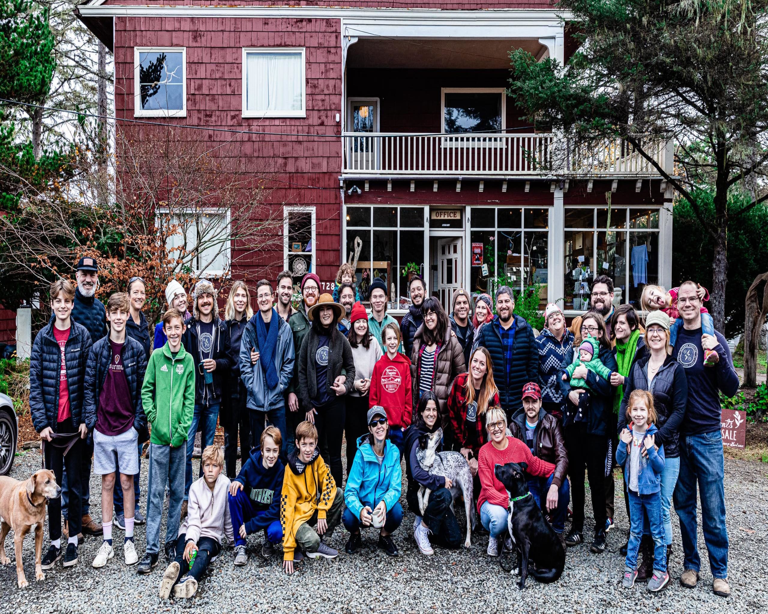 Group photo of Murmur Creative team and families in front of the Sou'wester Lodge, showcasing a vibrant community atmosphere during their studio retreat in Seaview, Washington.