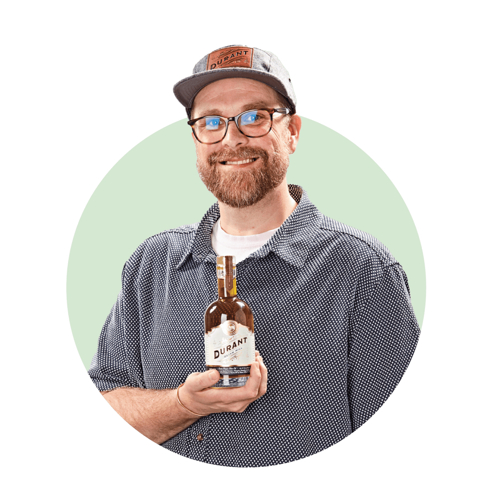 Lee McCollins holding Durant olive oil bottle