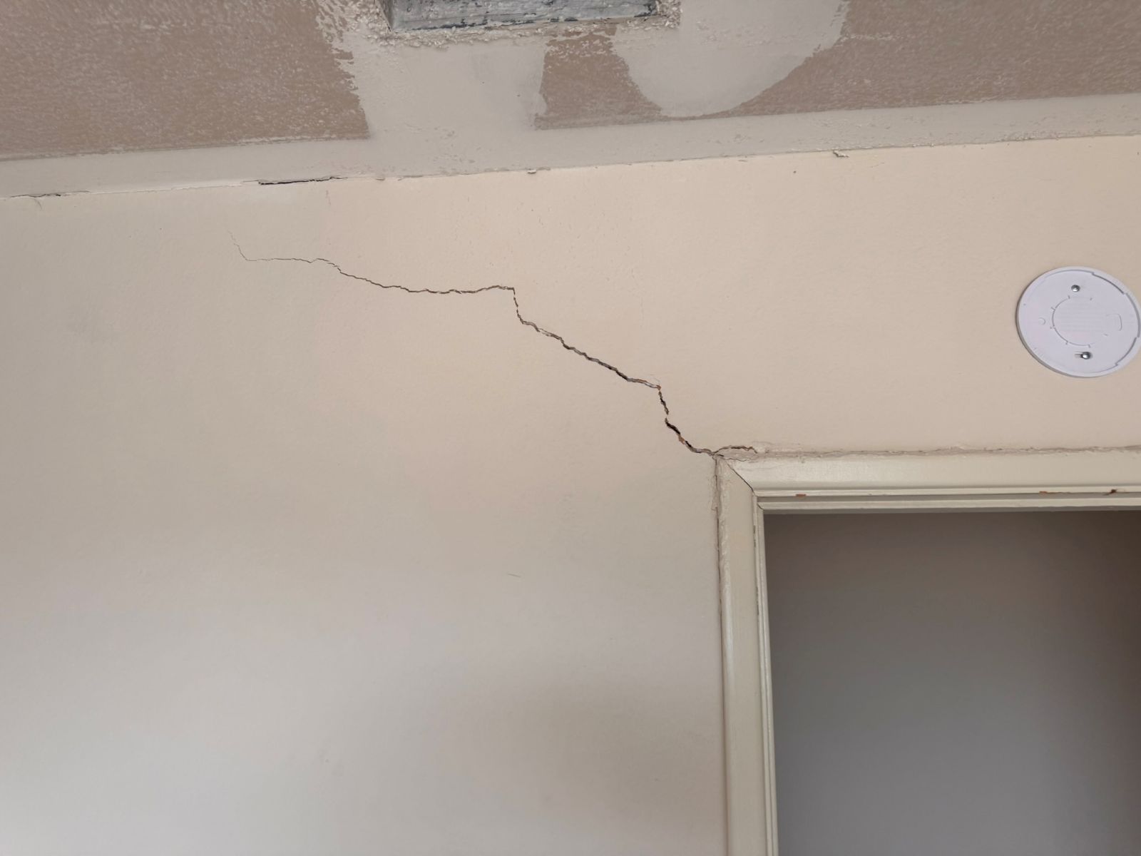 Structural crack running along wall above door frame - a warning sign of foundation movement in a flipped San Diego home