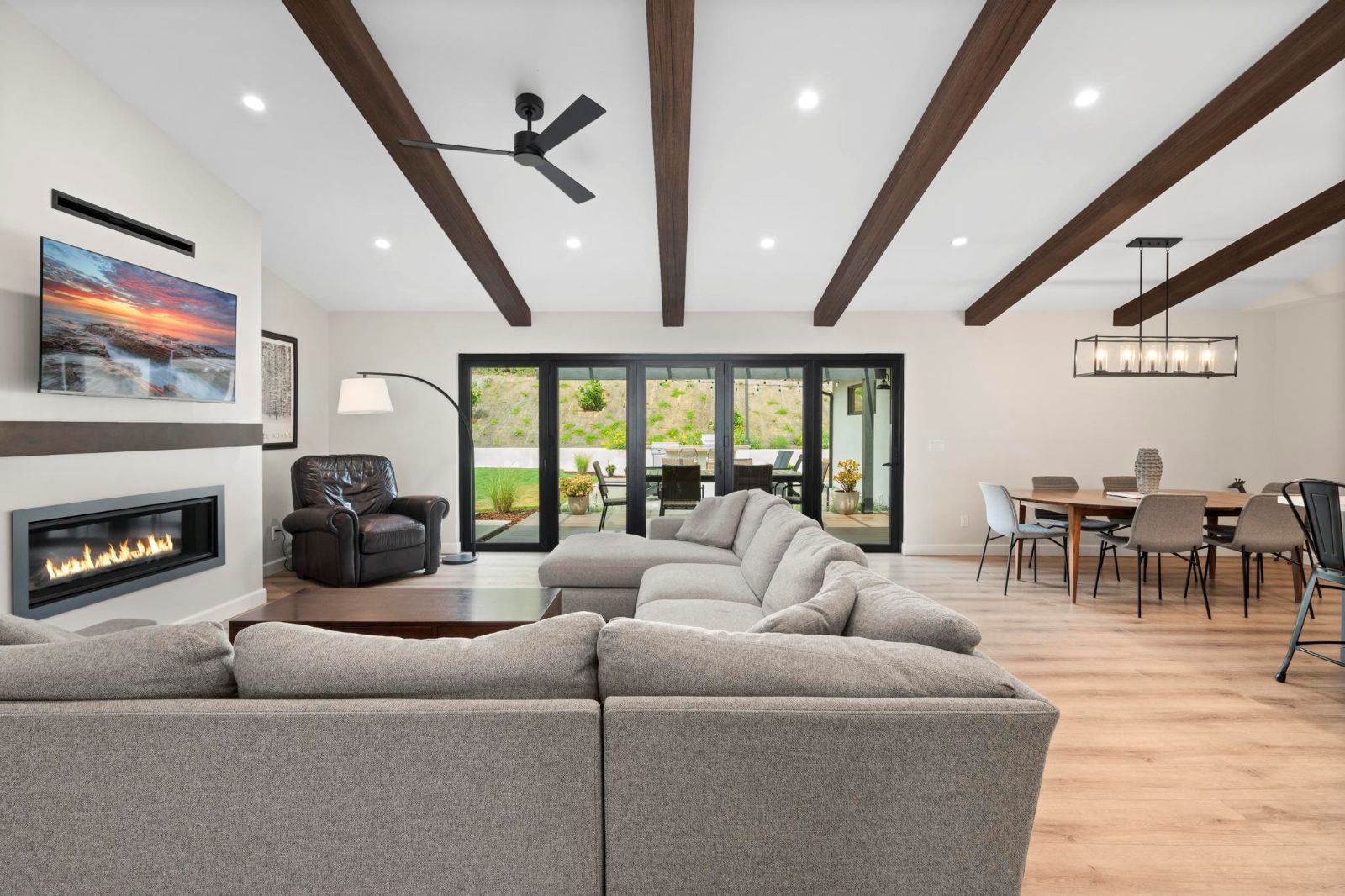 Open-concept great room remodel with wood beam ceiling and indoor-outdoor living in Del Mar by Murray Lampert Design, Build, Remodel