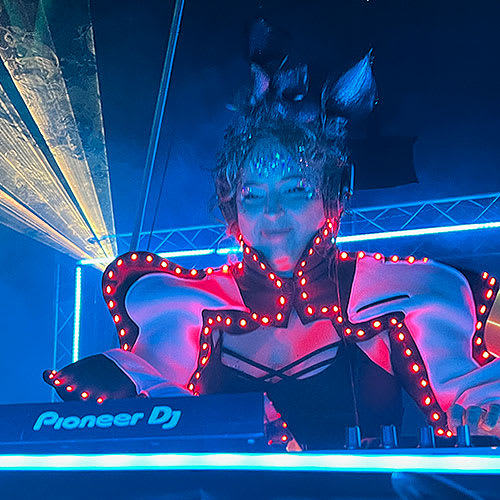 Portrait of DJ Haute Mess blowing magical fairy dust