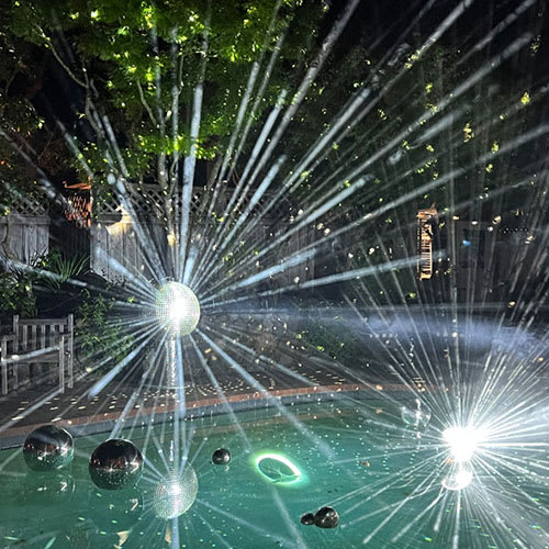 Disco balls in a pool with beams of light