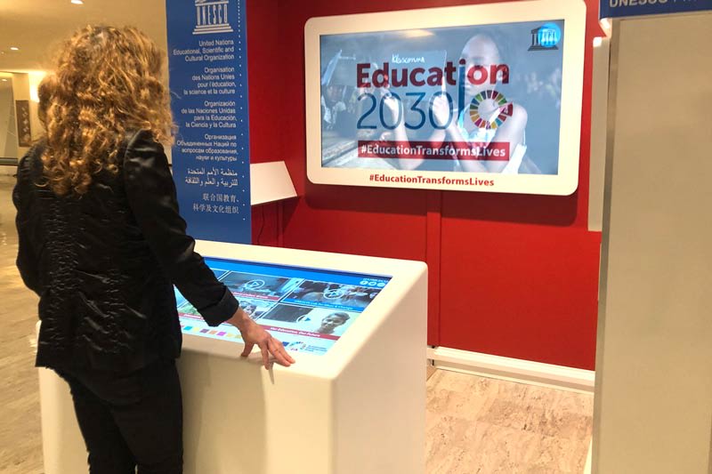 Person watching videos at the Unesco Kiosk