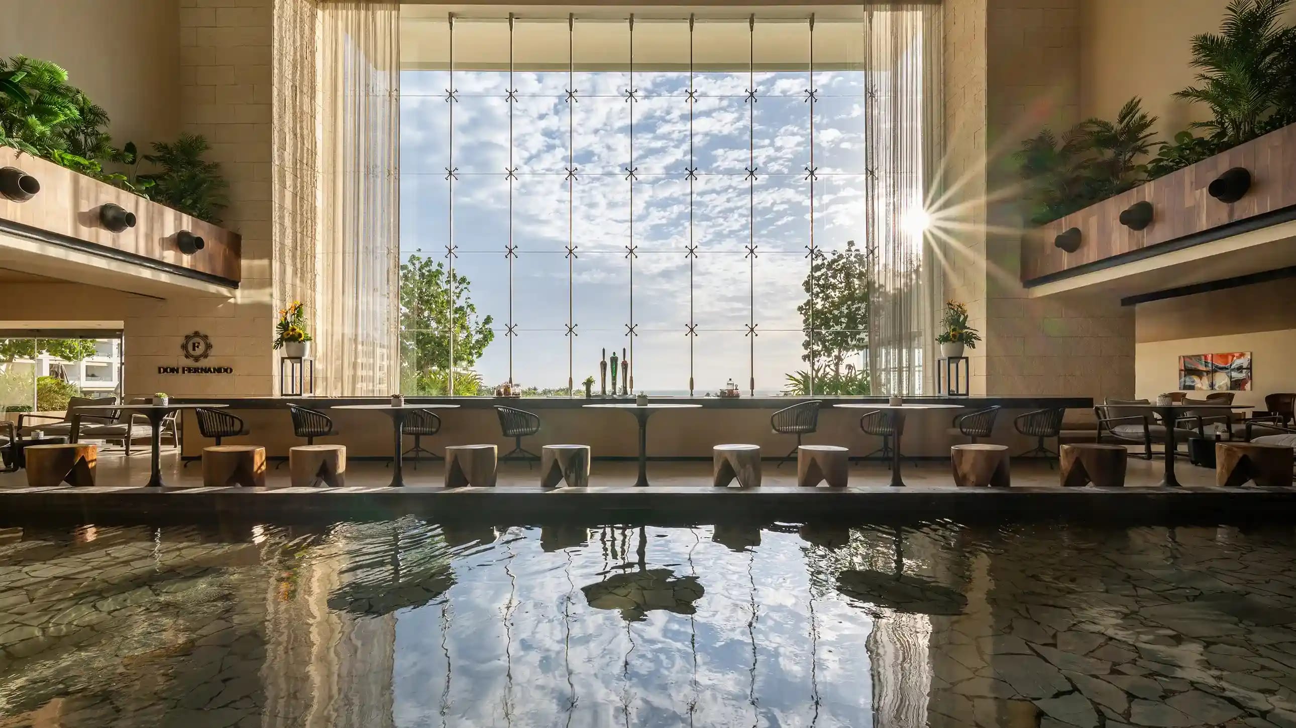 Spacious modern conference hall in Cancun with theater-style seating arrangement, large projection screen, professional stage lighting, sound system, and podium. Ideal venue for MICE events including conferences, seminars, corporate meetings, exhibitions, and large-scale presentations.