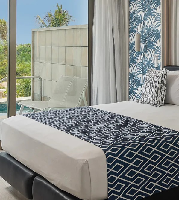 Modern luxury suite at Catalonia Grand Costa Mujeres featuring a private terrace with pool access, ideal for executive incentive travel, VIP corporate guests, and high-end business travelers in Mexico.