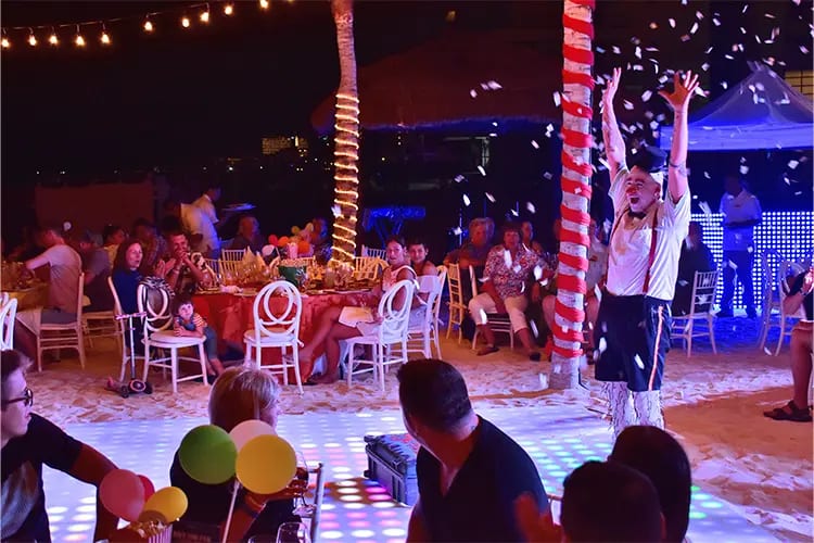 Vibrant pool deck and beachfront view at Hotel NYX Cancun. A versatile outdoor venue for MICE industry networking events, sunset corporate cocktail receptions, and high-impact incentive travel programs in the Cancun Hotel Zone, Mexico.