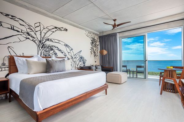 Daytime view of the expansive pool area and modern facade at Hyatt Vivid Grand Island. An upscale adults-only venue in Cancun perfect for MICE outdoor networking, team-building activities, and luxury corporate incentive travel programs in Mexico.