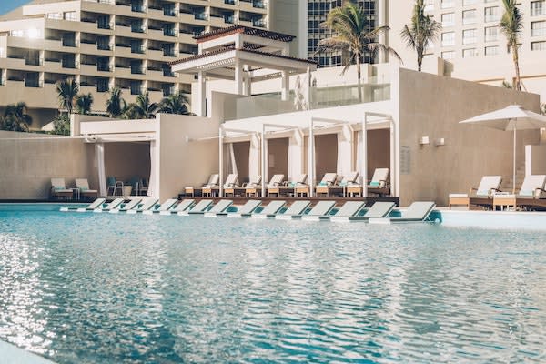 High-angle view of Iberostar Selection Cancun, featuring its unique pyramid architecture and 108,000 square feet of conference space. An elite MICE destination in Mexico offering 22 versatile meeting rooms, an on-site convention center, and beachfront networking terraces for large-scale international congresses.