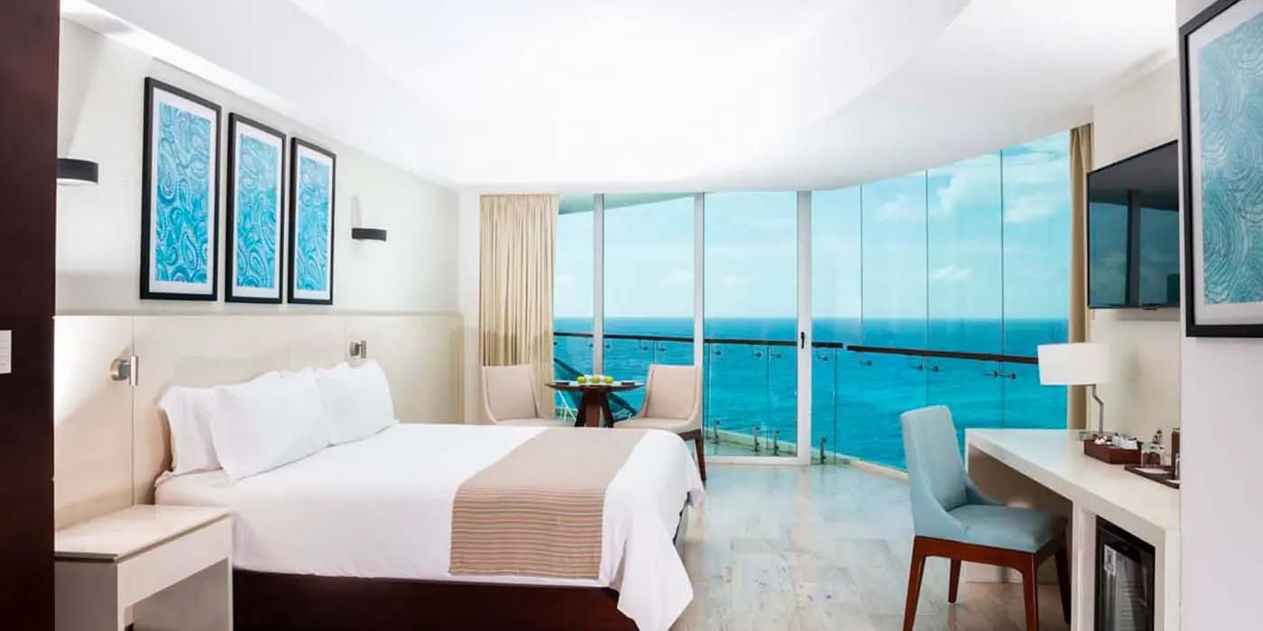 High-angle aerial view of Krystal Grand Cancun All Inclusive in Punta Cancun, featuring the exclusive Altitude Tower and multi-level infinity pools. A key MICE industry resort with over 13,000 square feet of flexible meeting space, executive boardrooms like Arena and Brisa, and outdoor terraces for corporate networking and premium incentive travel in the Cancun Hotel Zone.