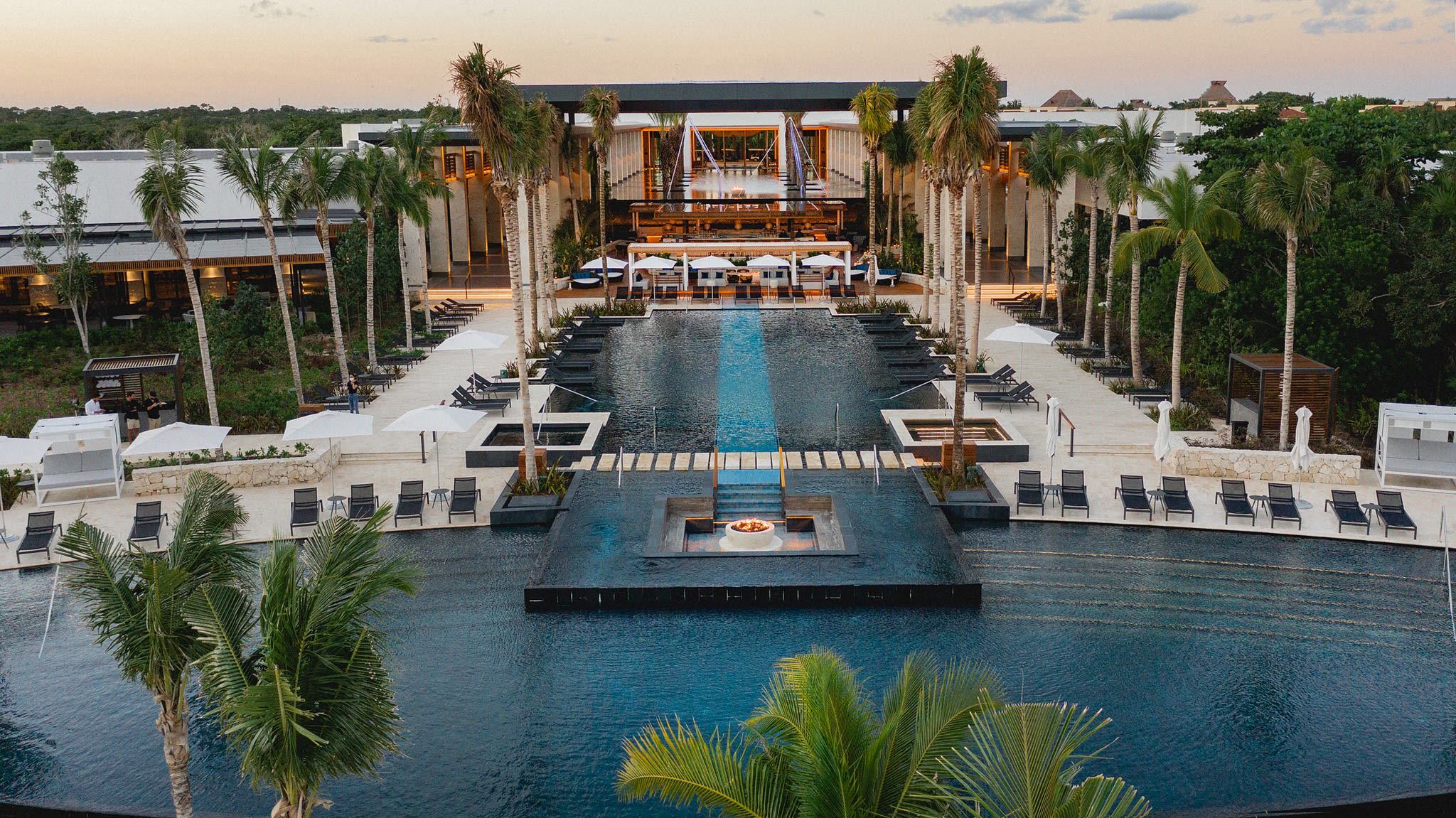 Aerial view of Conrad Tulum Riviera Maya, a luxury beachfront resort in Mexico ideal for incentive travel programs, executive retreats, and corporate meetings, showcasing pristine Caribbean waters, event-ready beachfront areas, and upscale poolside venues.