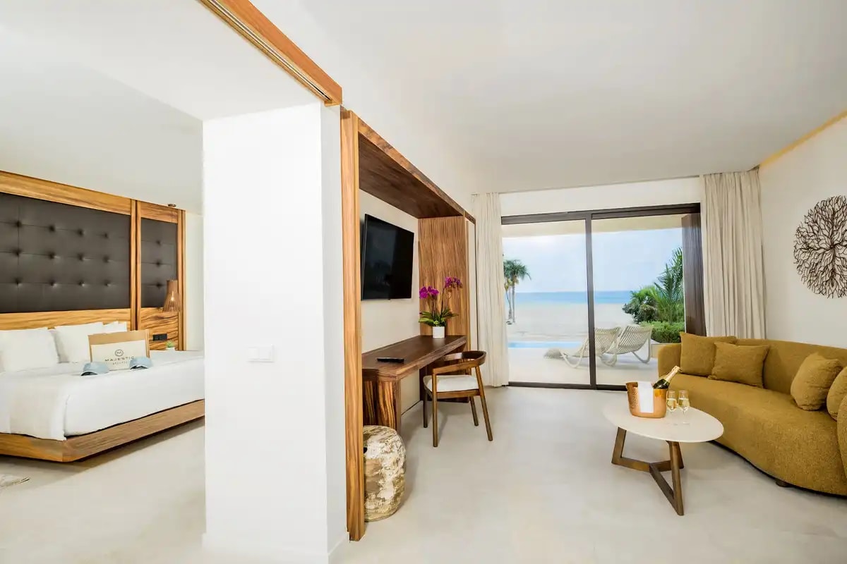 Luxurious swim-up suite at Majestic Mirage Costa Mujeres featuring a private terrace with direct pool access, ideal for high-end incentive travel rewards and VIP executive accommodations for MICE groups in Mexico
