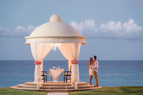 Luxury executive guest room at Marriott Cancun Resort featuring a private ocean-front balcony, seating area, and elegant workspace, perfect for corporate incentive travel winners and business event delegates.