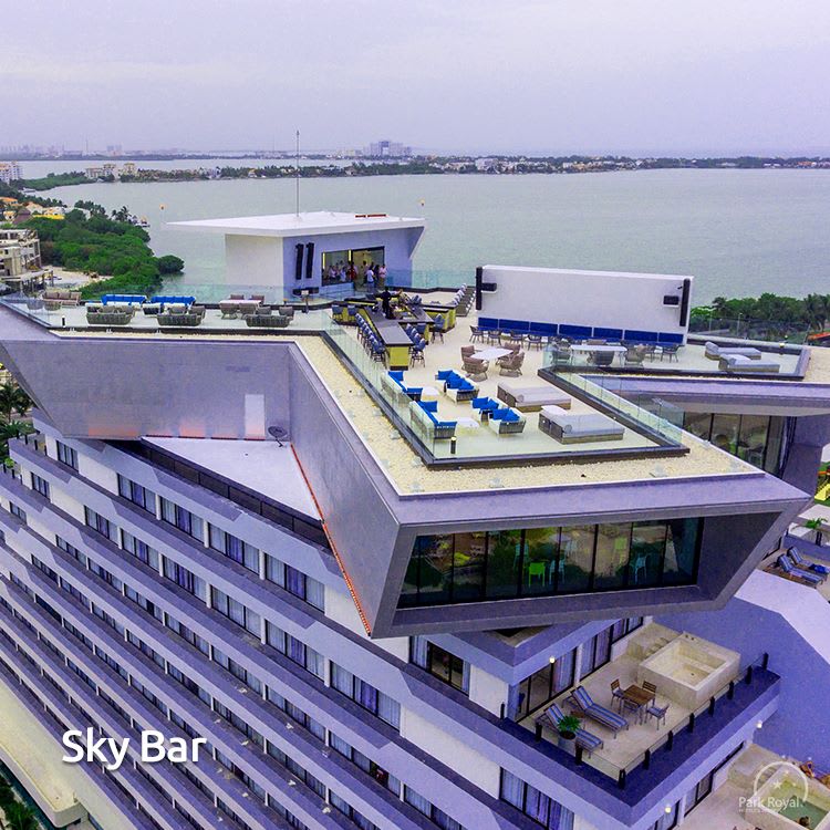 Aerial view of the modern Sky Bar rooftop lounge at Park Royal Cancun, showcasing an expansive outdoor venue for corporate cocktail receptions, evening networking mixers, and MICE incentive group celebrations overlooking the lagoon.
