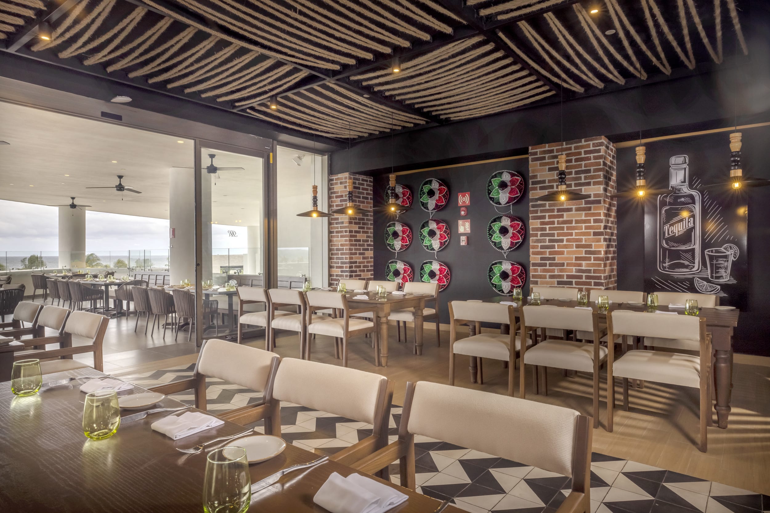Mexican-themed restaurant at Royalton Splash Riviera Cancun featuring sombrero decor, oceanview seating, and elegant table settings—ideal for MICE group dining, incentive travel meals, and cultural networking events.