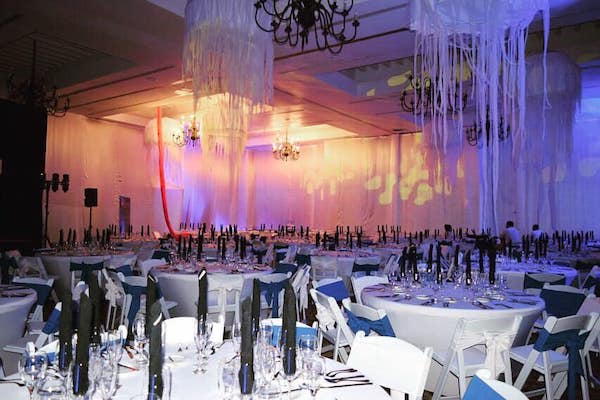 Elegant banquet hall at Sandos Cancun Luxury Experience Resort featuring round tables, chandeliers, and ambient lighting—ideal for MICE galas, corporate dinners, and formal networking events in Mexico.