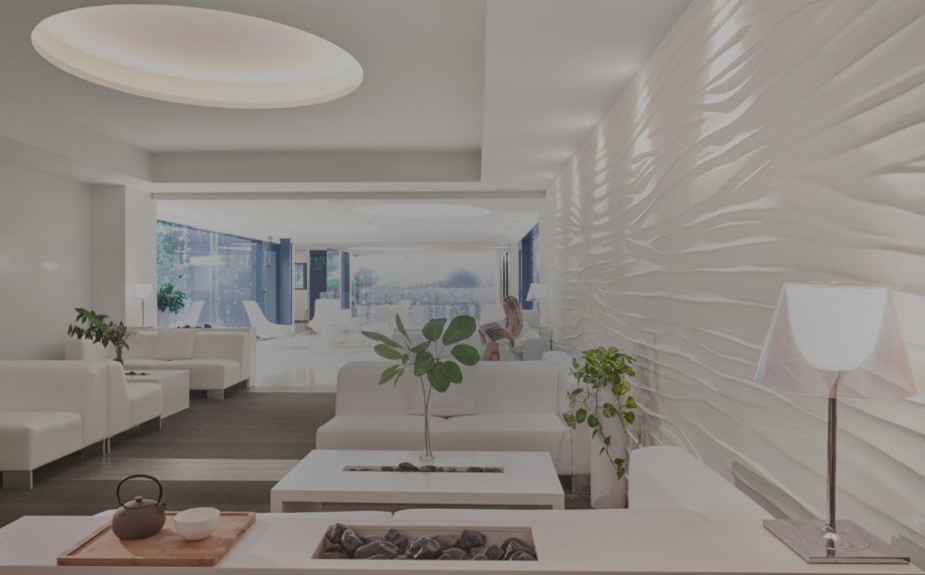 Minimalist lounge at SHA Wellness Clinic Mexico featuring white furniture, ambient lighting, and natural accents—ideal for MICE guests seeking w
