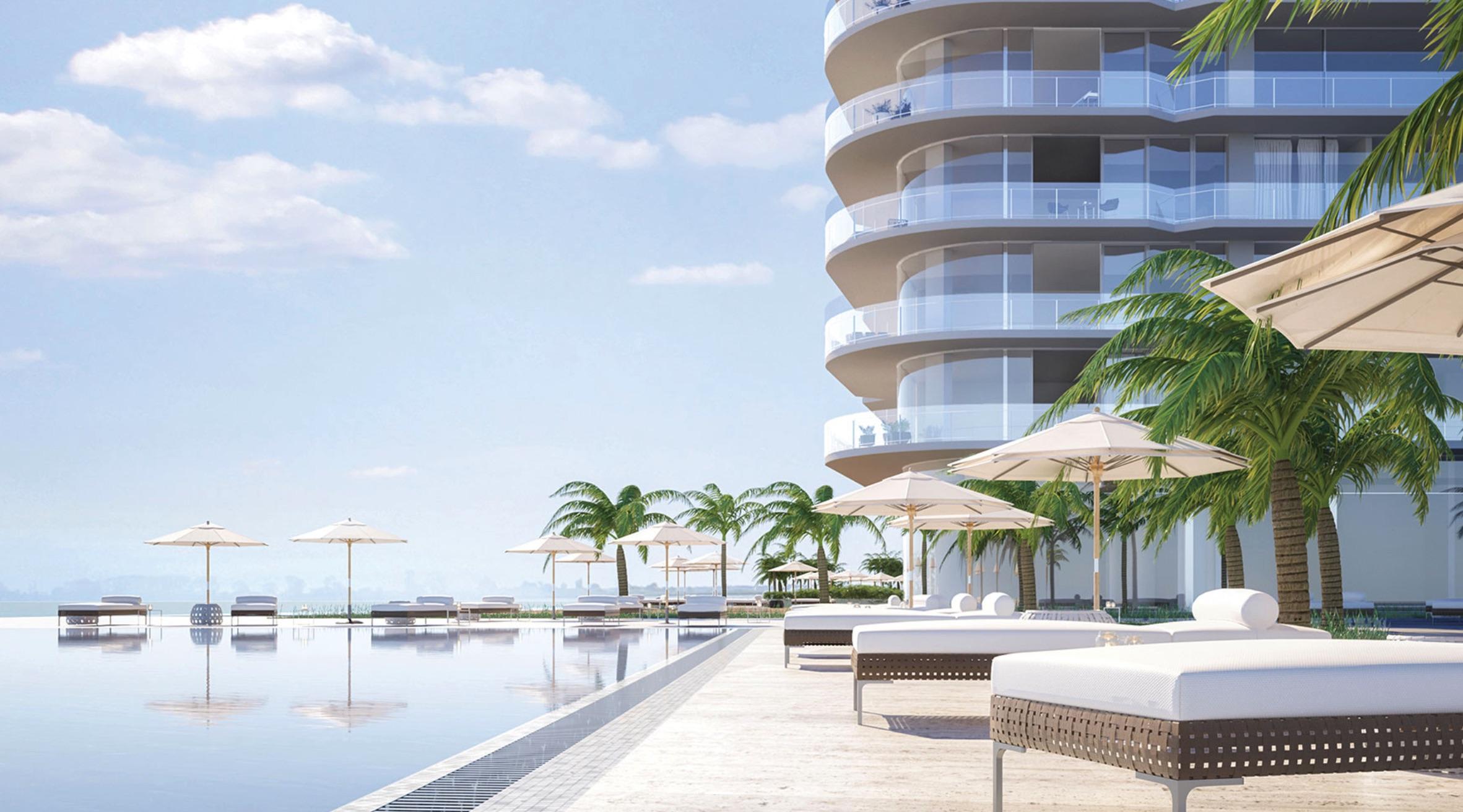 Luxurious beachfront resort in Cancun showcasing curved balconies, white cushioned loungers, and an elegant infinity pool—ideal for hosting MICE retreats, incentive groups, and executive meetings in a tropical setting.