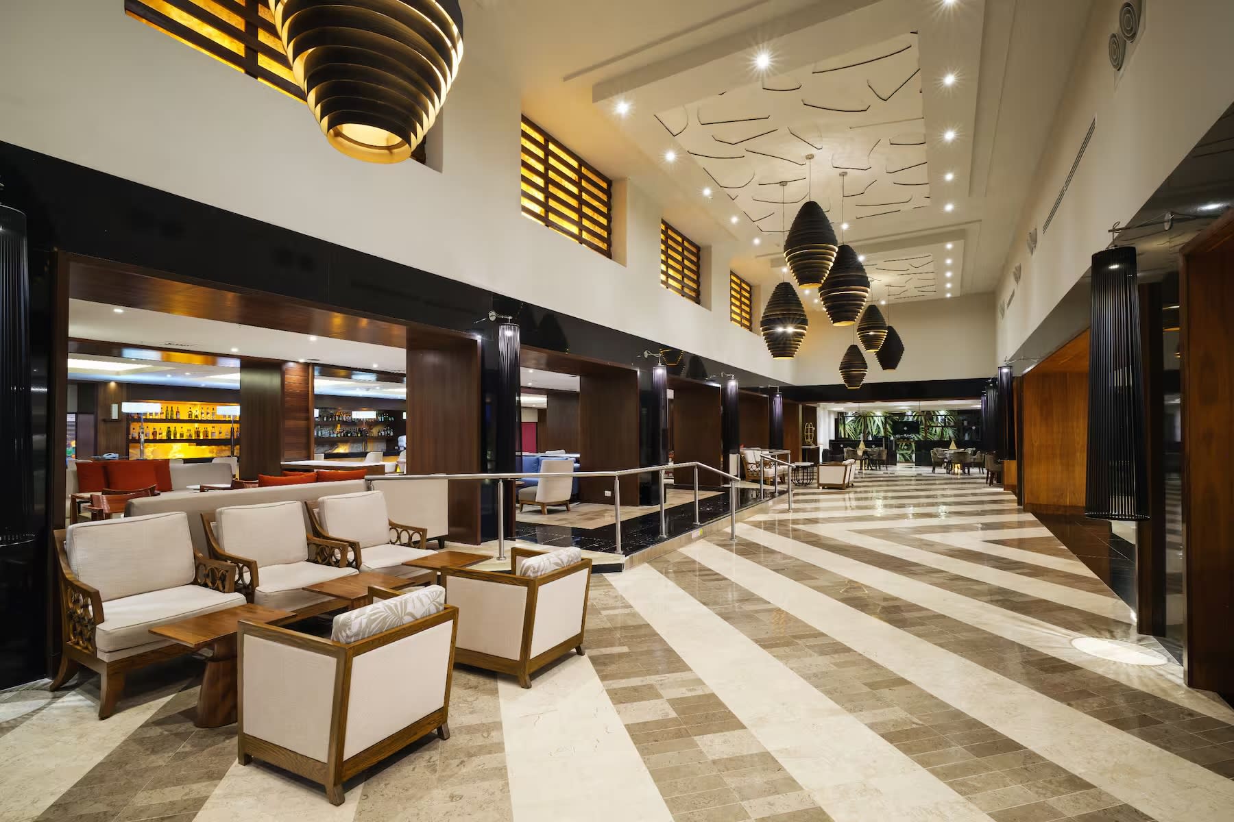 Panoramic view of the lobby of the Wyndham Grand Cancun All Inclusive Resort & Villas, highlighting its luxurious architecture suitable for large-scale MICE events, corporate conventions for 650 guests, and luxury incentive travel programs in Mexico.