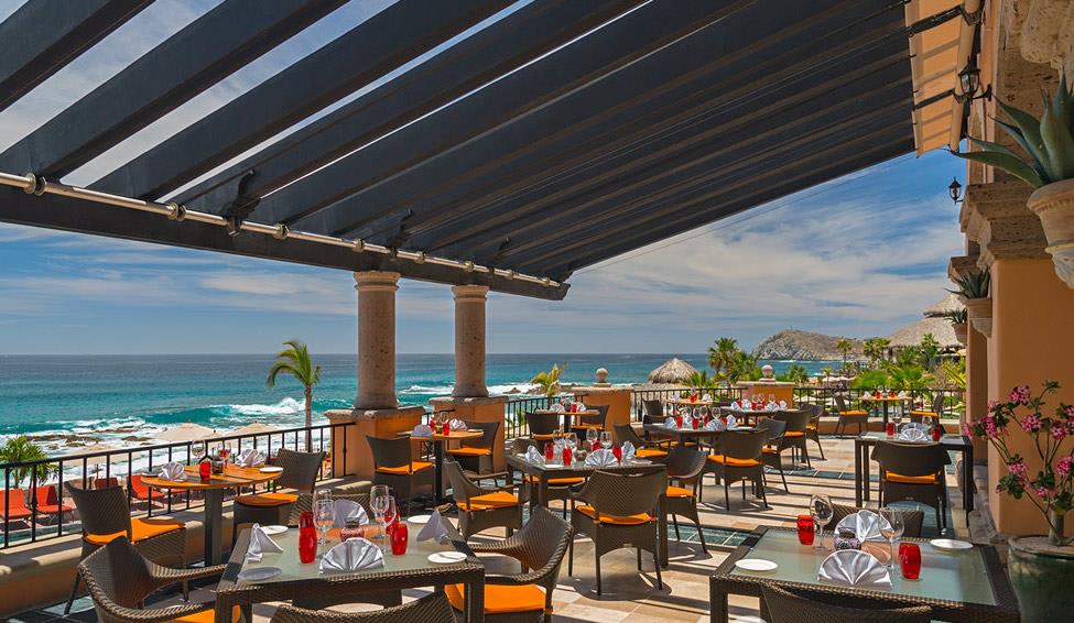 Oceanfront dining terrace at Hacienda del Mar Los Cabos featuring shaded pergola, vibrant seating, and panoramic coastal views—ideal for MICE welcome dinners, executive luncheons, and incentive group experiences in Baja California Sur.