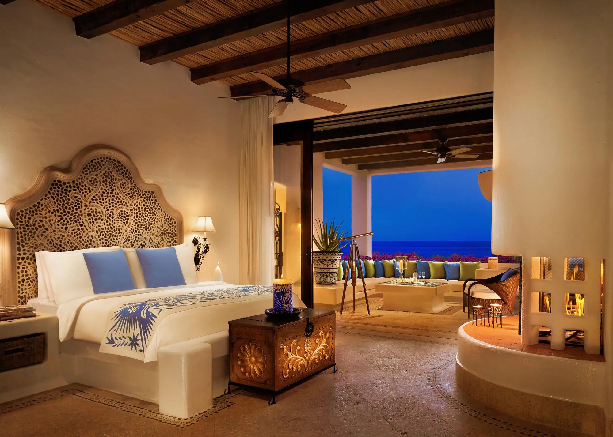 Luxury suite at Las Ventanas al Paraíso featuring carved wood accents, oceanview terrace with lounge seating, telescope, and fireplace—ideal for MICE executive stays, incentive travel, and VIP accommodations in Baja California Sur.