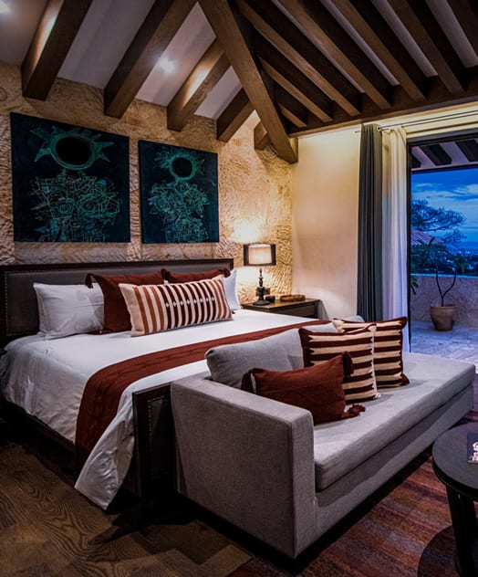 Rustic luxury suite in Oaxaca with mountain-view balcony, ideal for MICE guests seeking upscale accommodations during meetings and incentive travel programs.